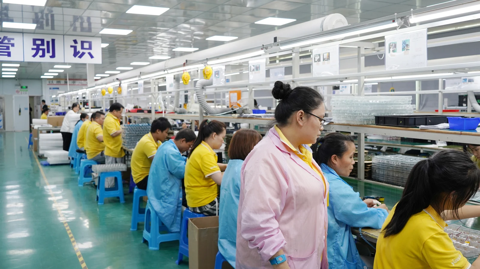 Operators and product trays on the assembly line